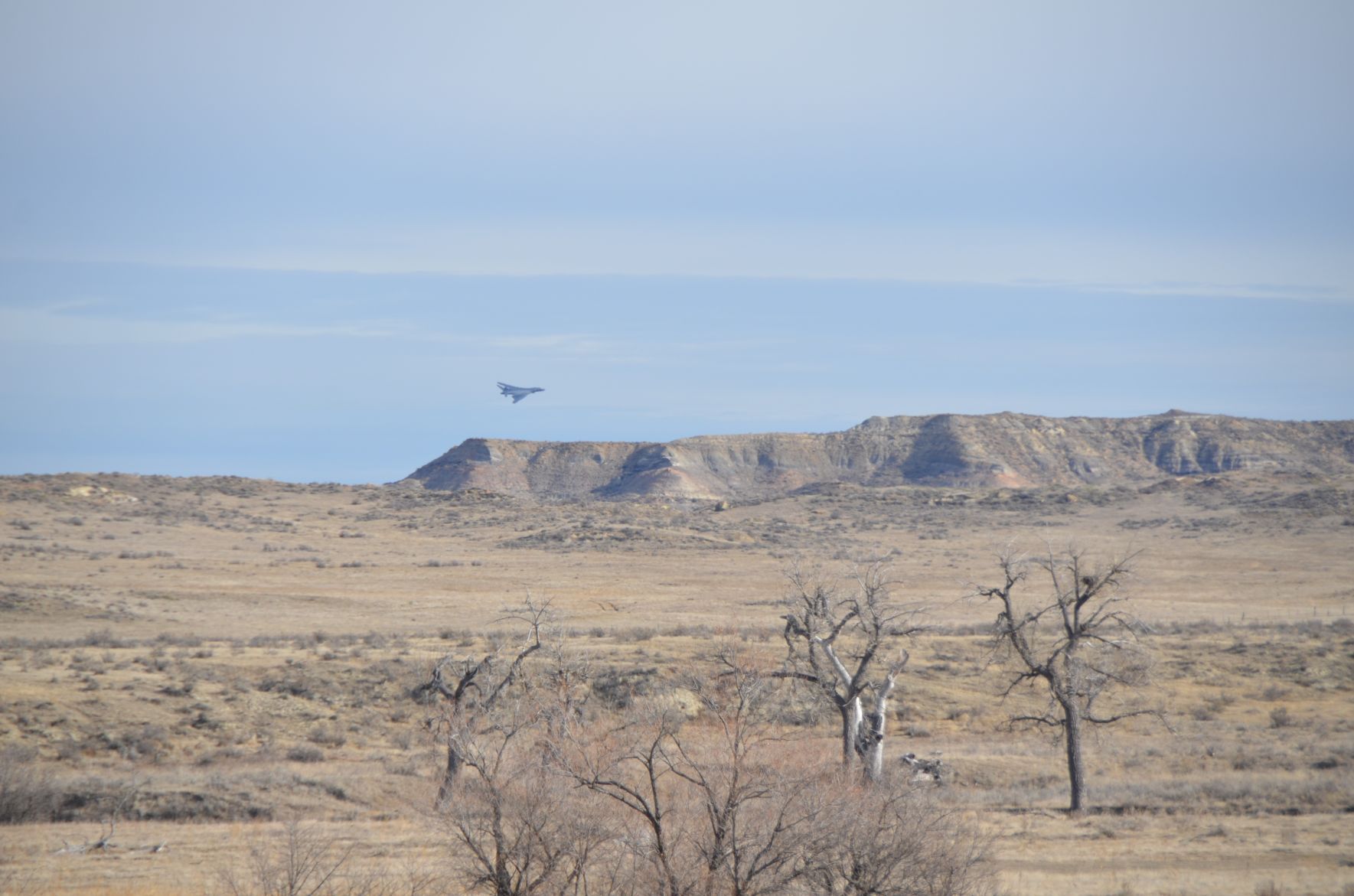Bomber flies over a ridge